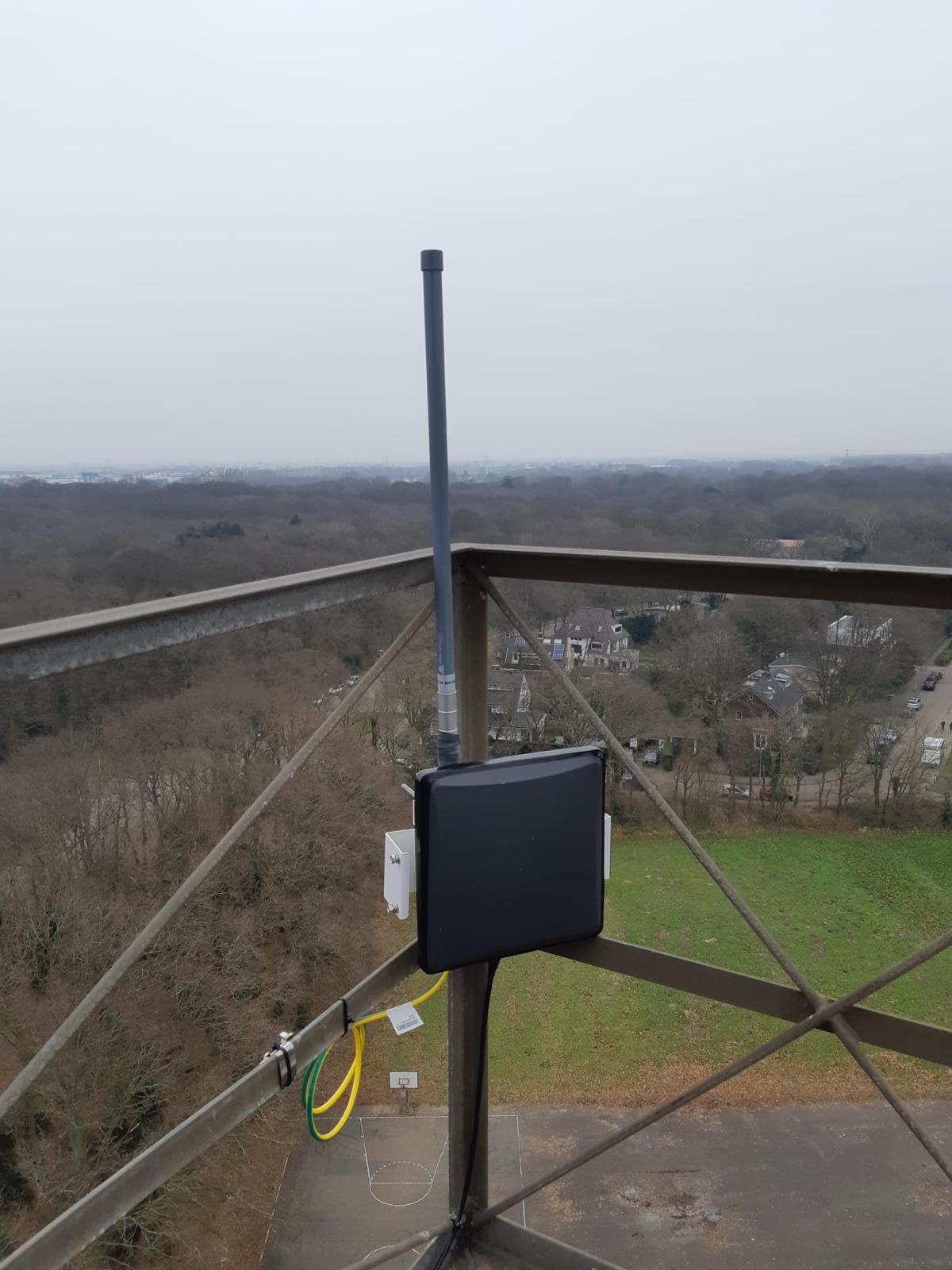 Gateway enclosure on a lattice tower overlooking woodland