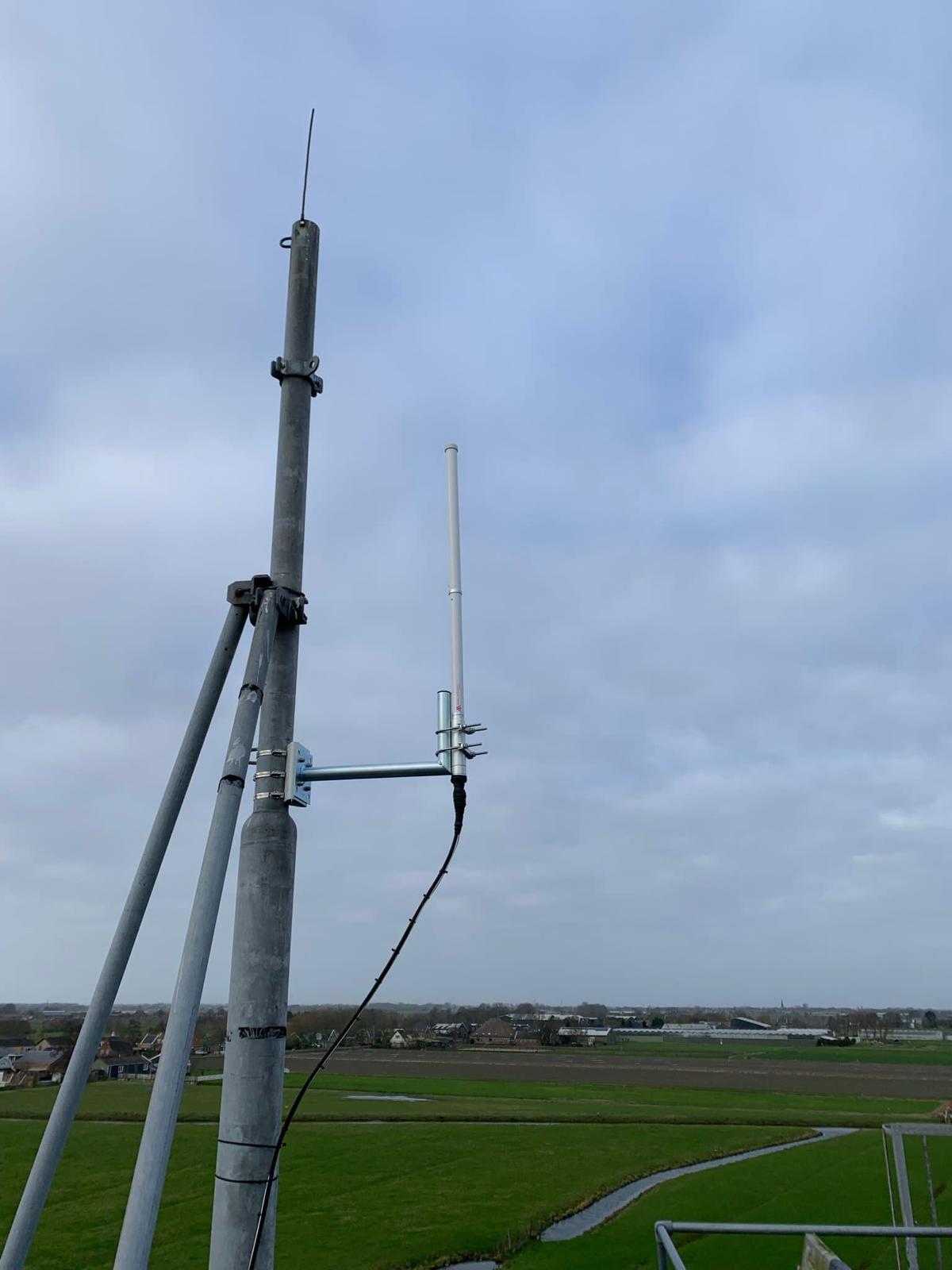 Antenna on a guyed mast over Dutch polder landscape