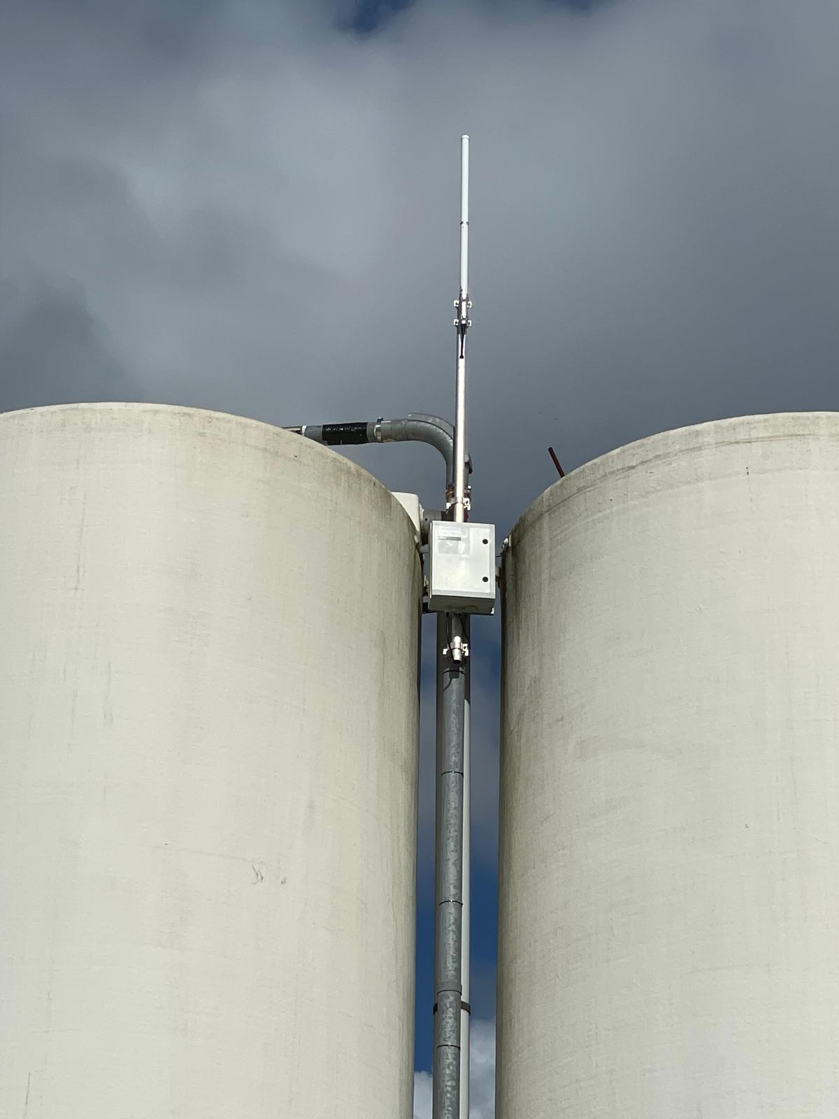Gateway enclosure mounted between concrete silos
