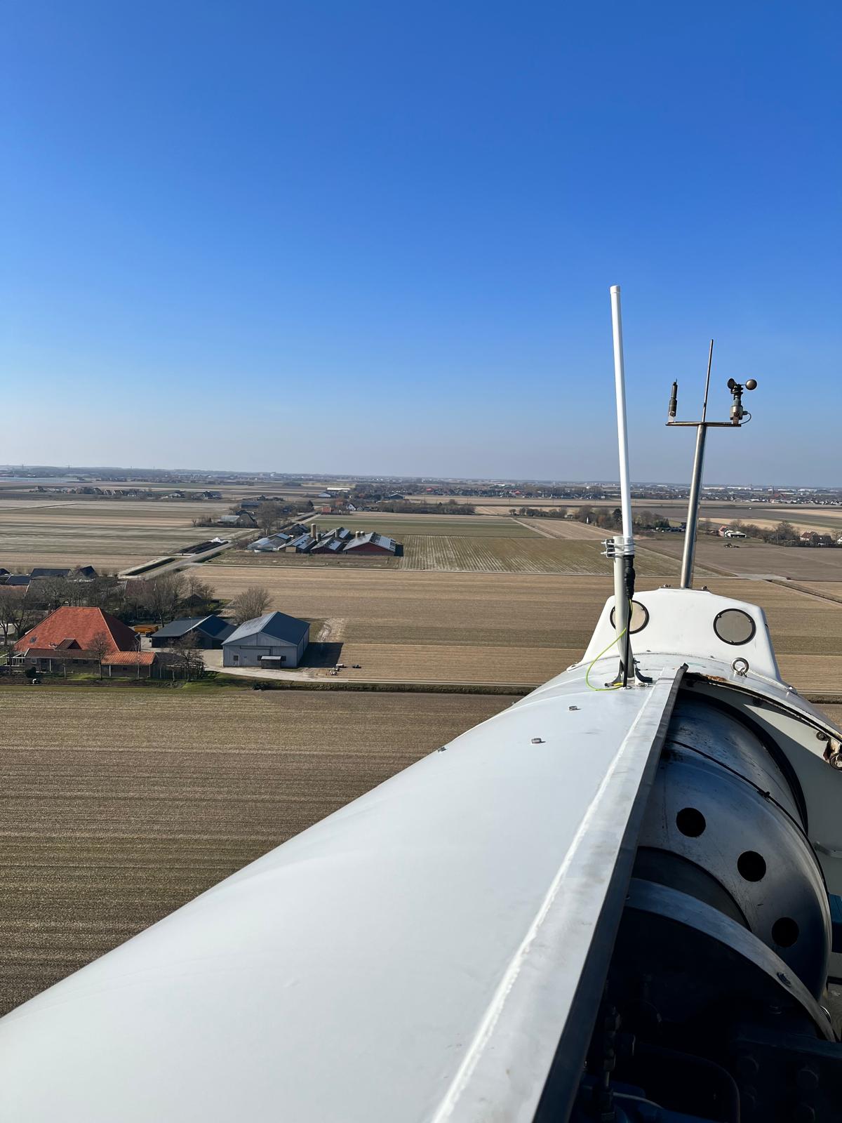 Antenna on a wind turbine nacelle over farmland